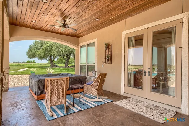 a patio with yard glass top table and chairs