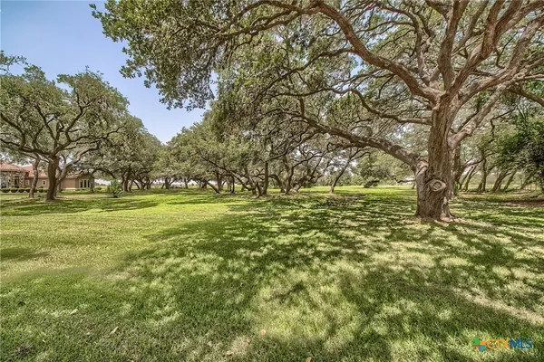 a large yard with lots of green space and trees
