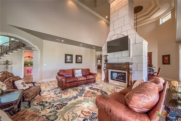 a living room with furniture a flat screen tv and a fireplace