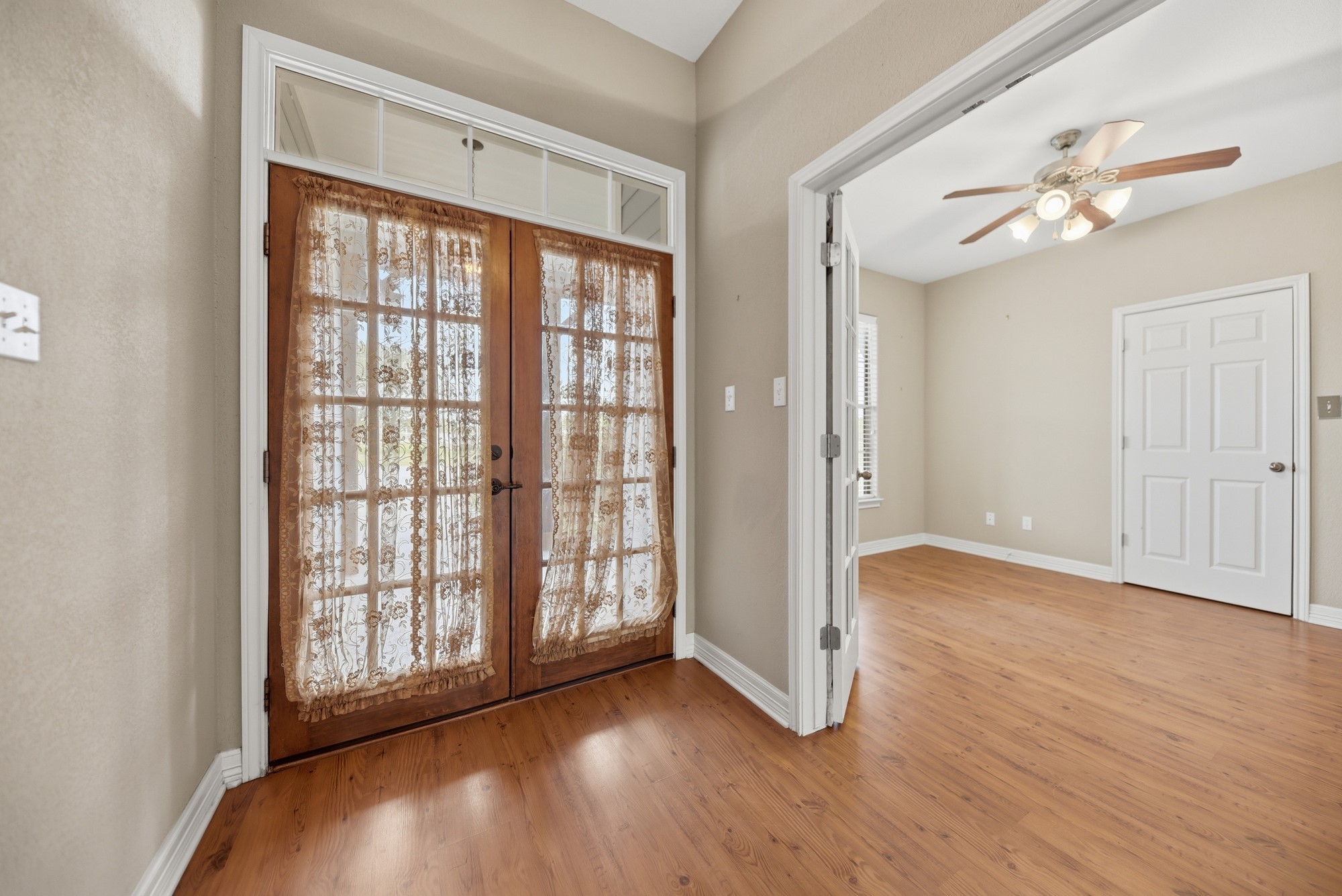 350 Owl Creek Road Giddings, TX 78942 - Photo 27 of 29 Foyer featuring ceiling fan, light wood finished floors, and french doors