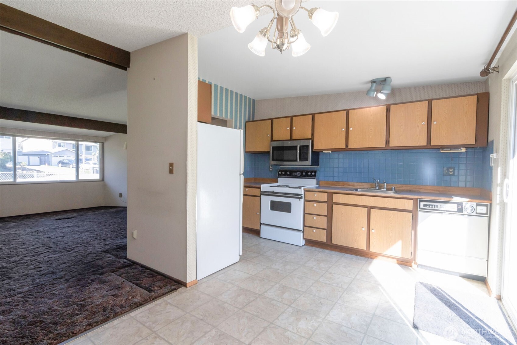 308 225th Street Southwest Bothell, WA 98021 - Photo 4 of 15 a kitchen with stainless steel appliances granite countertop a stove a sink and a refrigerator