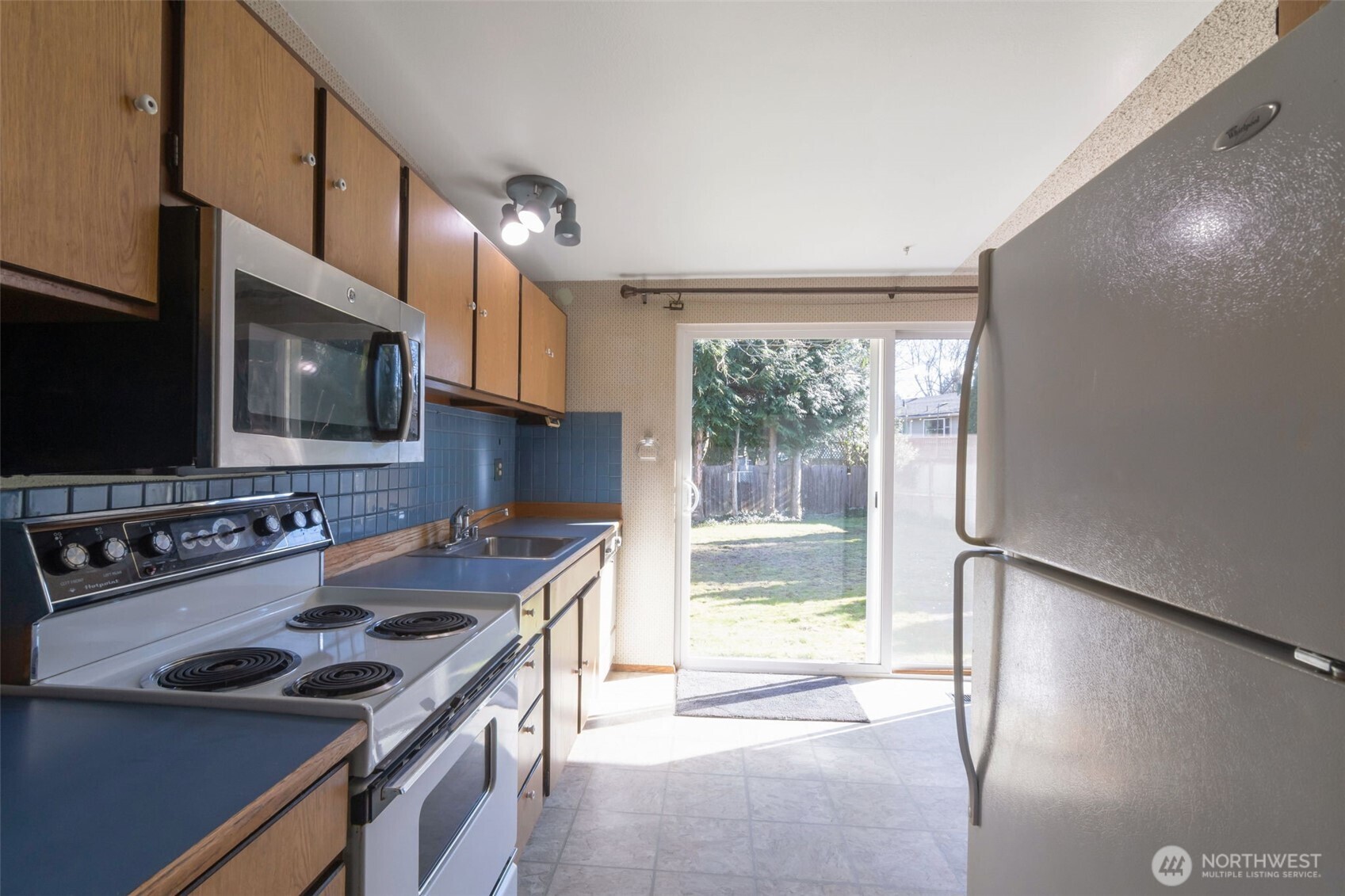 308 225th Street Southwest Bothell, WA 98021 - Photo 6 of 15 a kitchen that has a sink a stove and a microwave