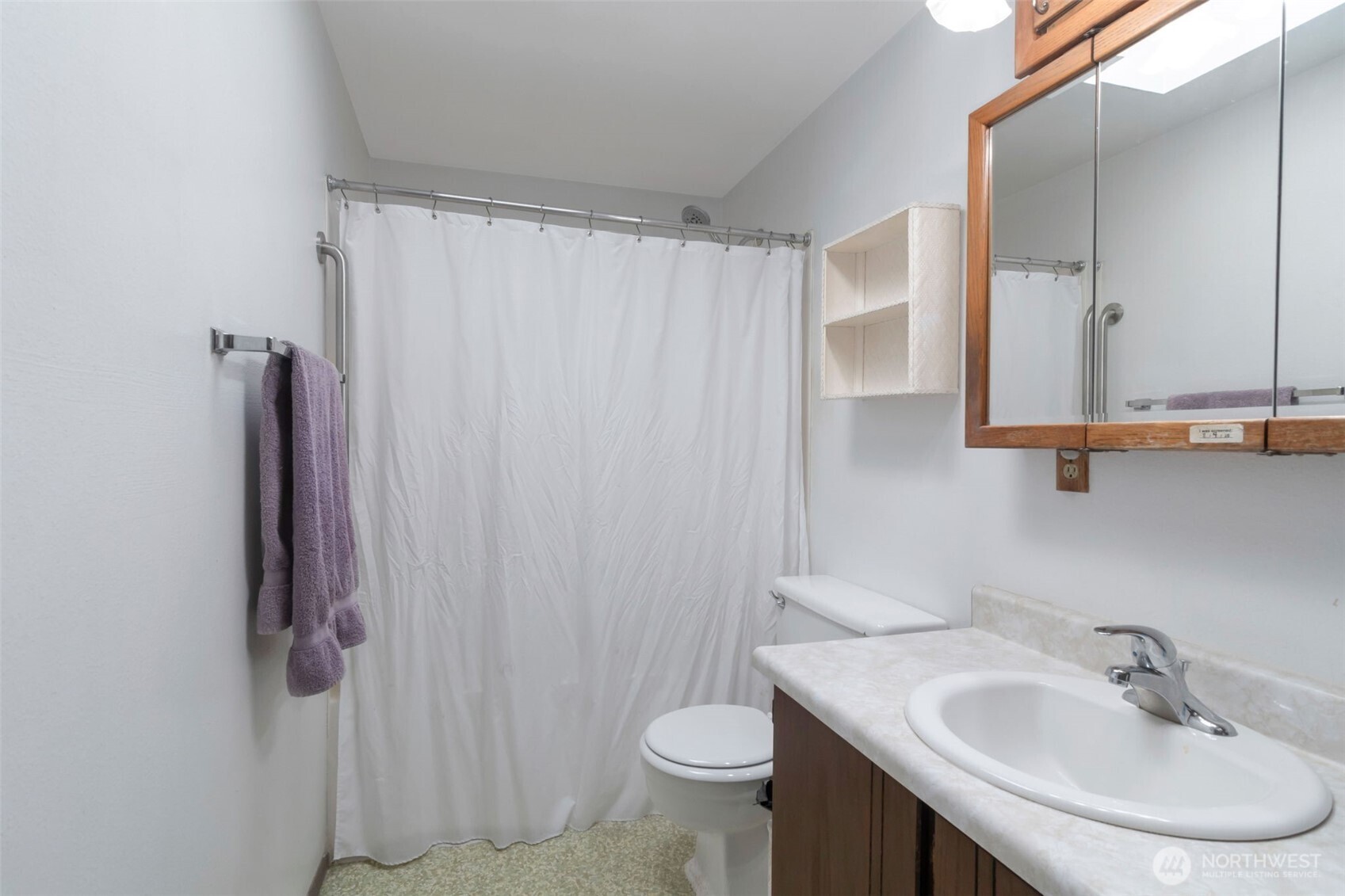 308 225th Street Southwest Bothell, WA 98021 - Photo 8 of 15 a bathroom with a sink a toilet and shower curtain