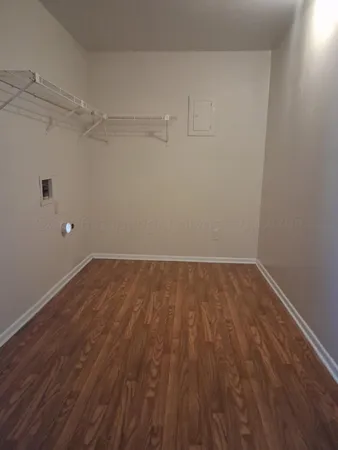 a view of a room with wooden floor