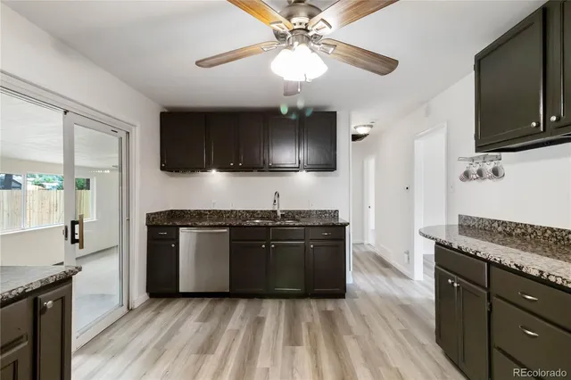 a kitchen with granite countertop stainless steel appliances and wooden cabinets