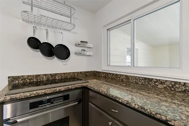 a kitchen with a sink and a stove top oven