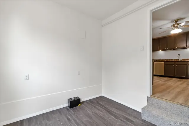 a view of a kitchen and an empty room