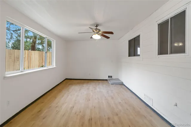 wooden floor in an empty room with a window