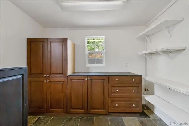 a view of a closet with wooden floor