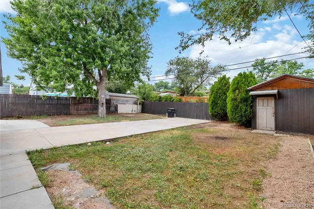 a view of backyard of house with green space