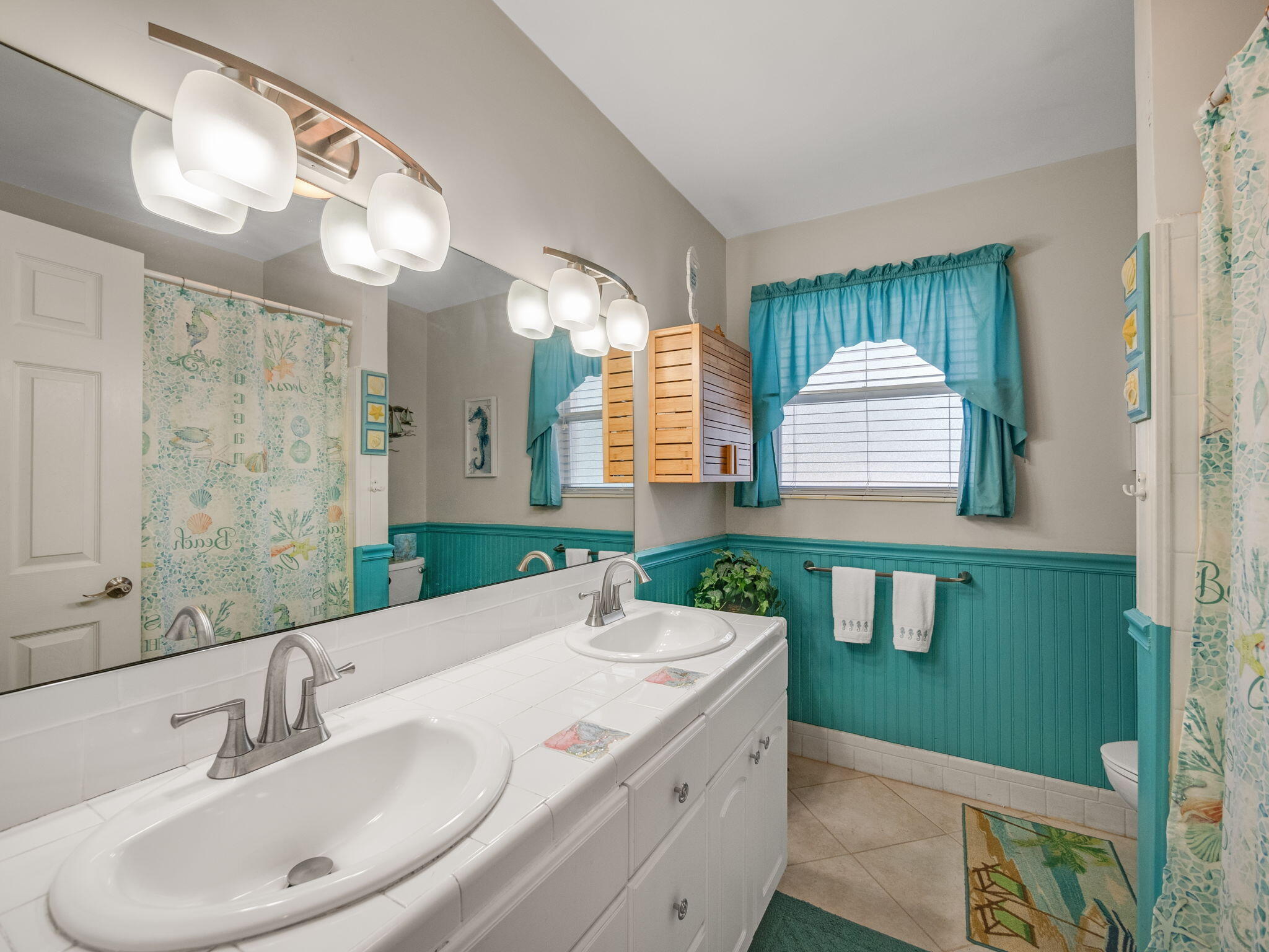 1196 Coral Way Singer Island, FL 33404 - Photo 15 of 17 a bathroom with a sink and a mirror
