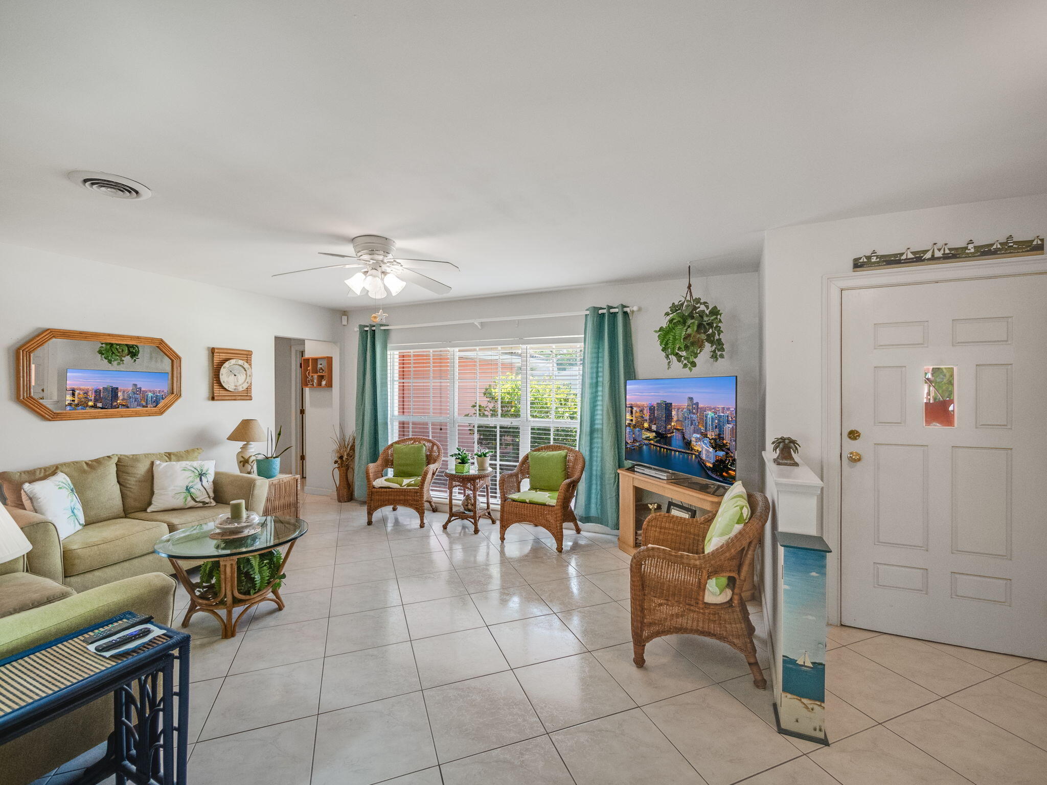 1196 Coral Way Singer Island, FL 33404 - Photo 3 of 17 a living room with furniture and a flat screen tv
