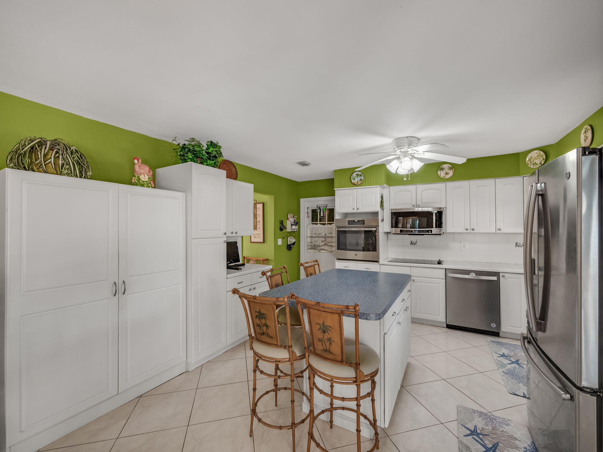 1196 Coral Way Singer Island, FL 33404 - Photo 6 of 17 a kitchen with refrigerator and chairs