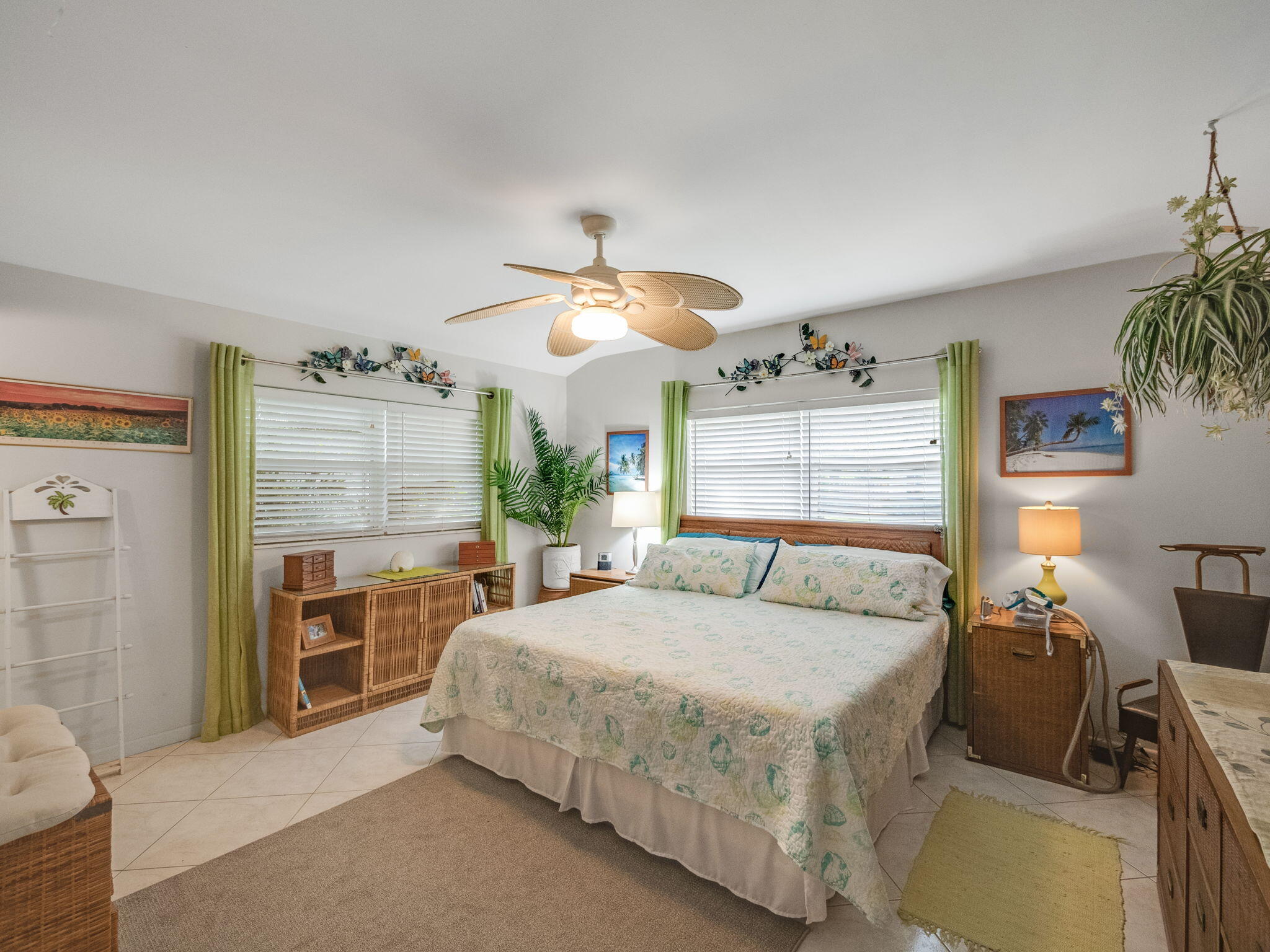 1196 Coral Way Singer Island, FL 33404 - Photo 8 of 17 a bedroom with a large bed and a chandelier