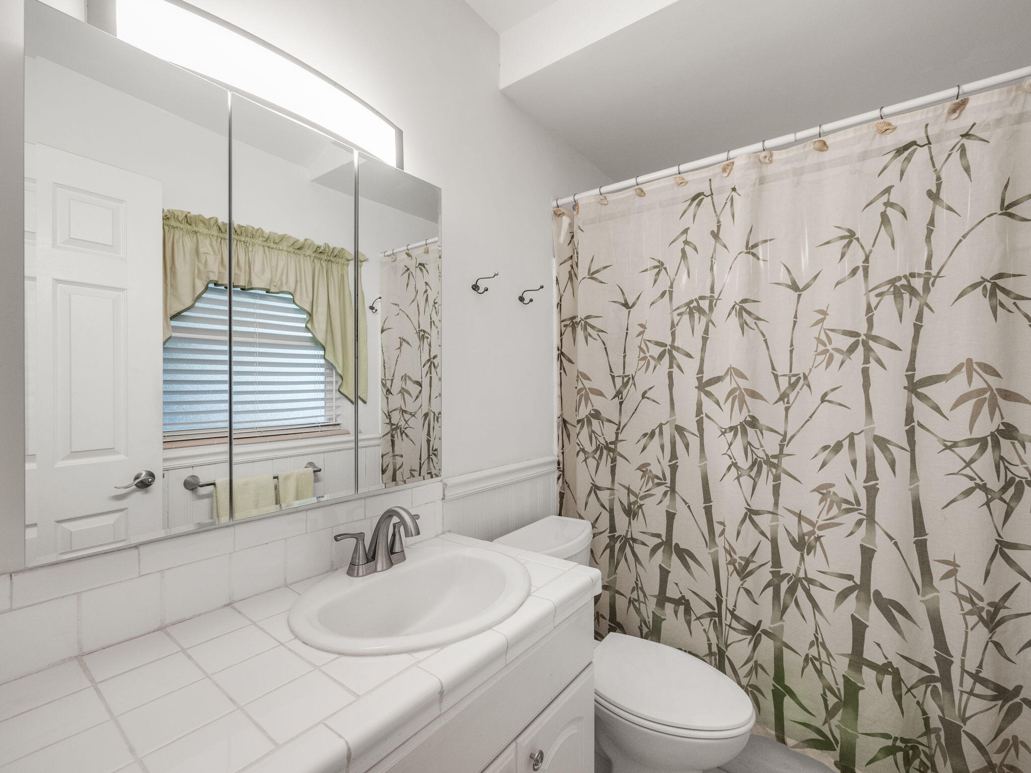 1196 Coral Way Singer Island, FL 33404 - Photo 9 of 17 a bathroom with a sink toilet and shower