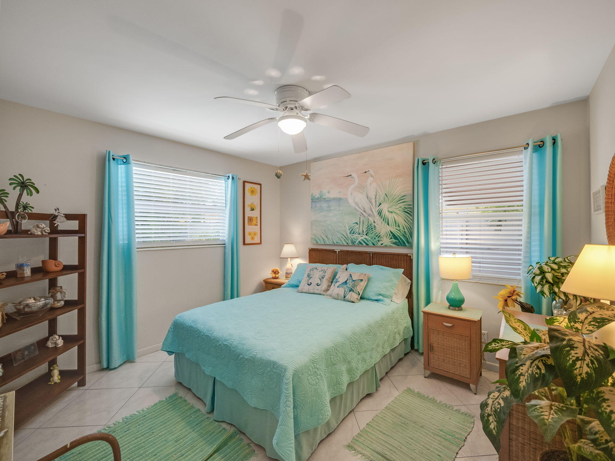 1196 Coral Way Singer Island, FL 33404 - Photo 10 of 17 a bedroom with a large bed and a chandelier