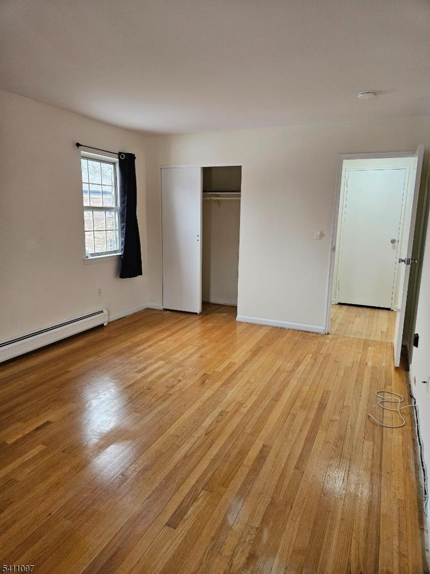 19 Savage Road, Unit 32D8 Denville, NJ 07834 - Photo 15 of 19 a view of an empty room with wooden floor and a window
