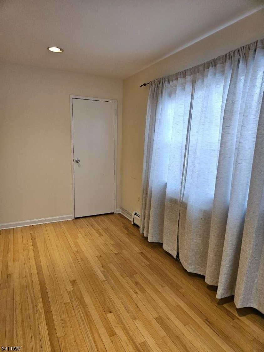 19 Savage Road, Unit 32D8 Denville, NJ 07834 - Photo 18 of 19 a view of an empty room with wooden floor and a window