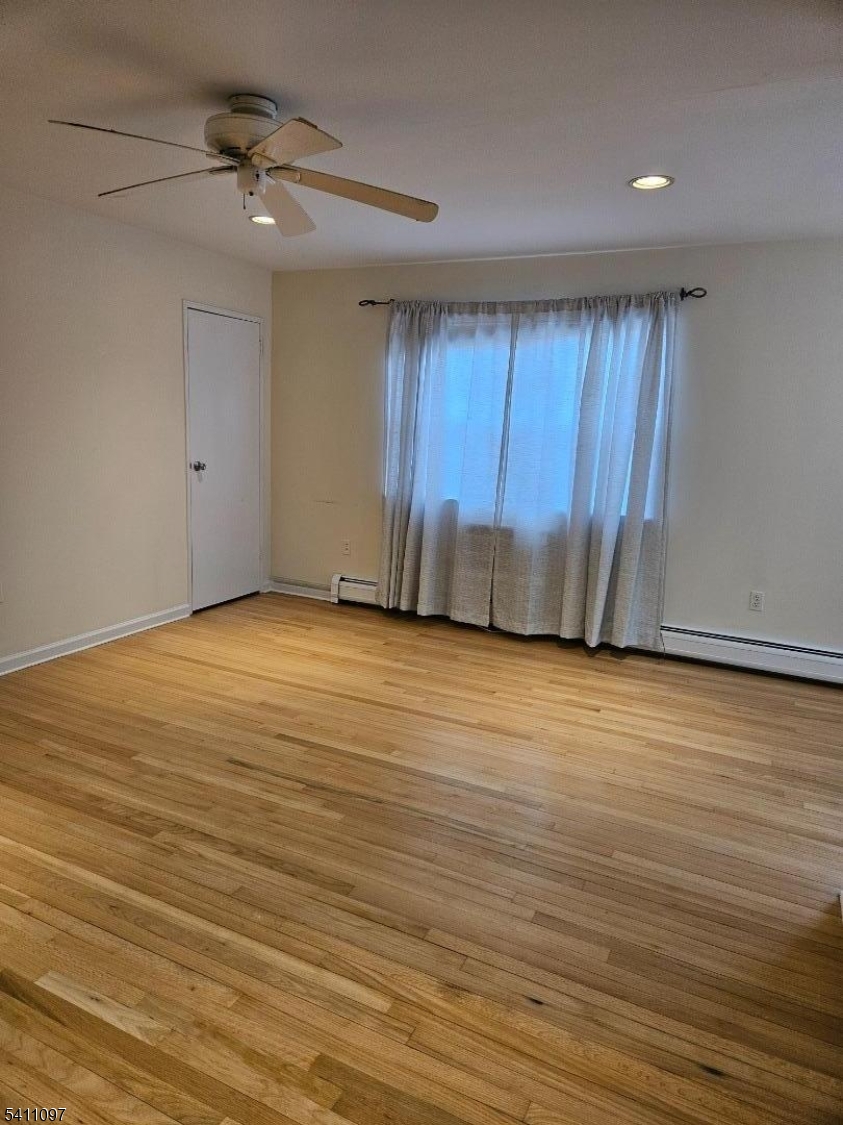 19 Savage Road, Unit 32D8 Denville, NJ 07834 - Photo 19 of 19 a view of an empty room with wooden floor and a window