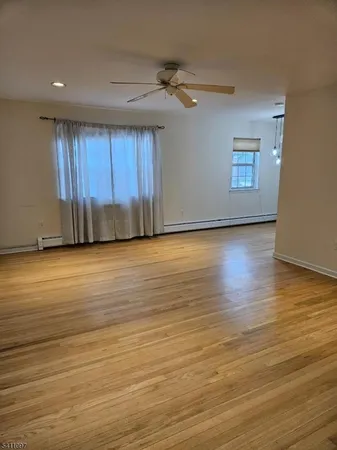 a view of a room with wooden floor