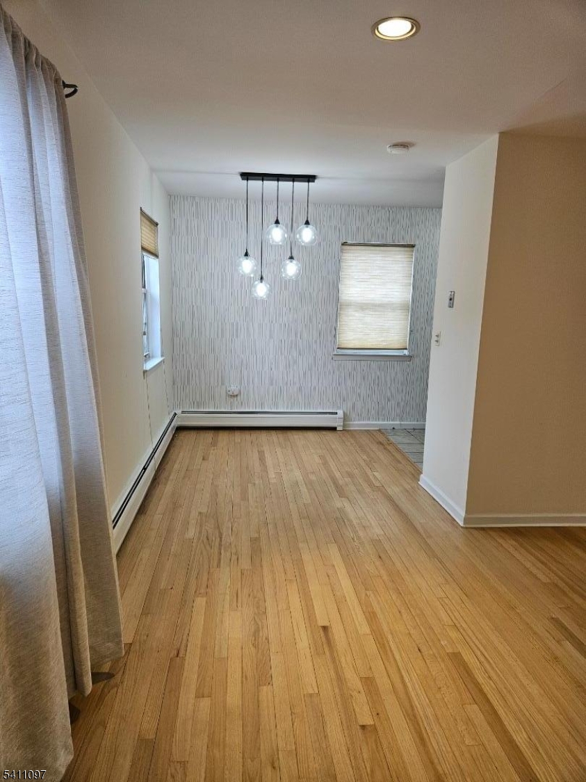 19 Savage Road, Unit 32D8 Denville, NJ 07834 - Photo 6 of 19 an empty room with wooden floor and windows