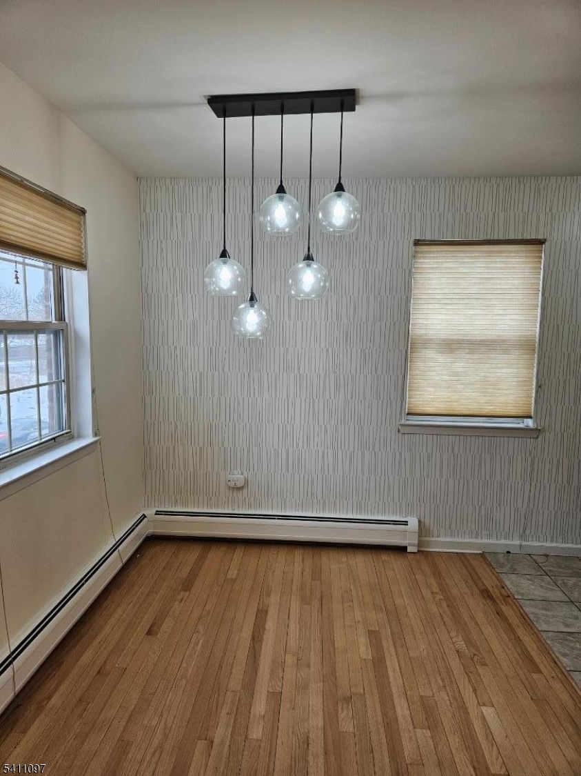 19 Savage Road, Unit 32D8 Denville, NJ 07834 - Photo 7 of 19 an empty room with wooden floor mirror and windows