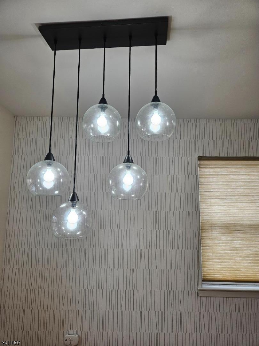 19 Savage Road, Unit 32D8 Denville, NJ 07834 - Photo 8 of 19 a view of a chandelier fan and fire place