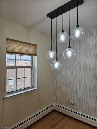 a view of a room with wooden floor and large window