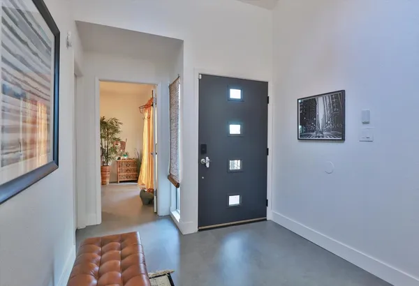 a living room with furniture a couch and potted plants