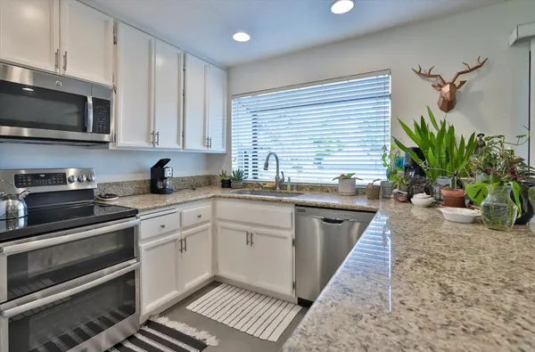 a living room with furniture a fireplace and a large window