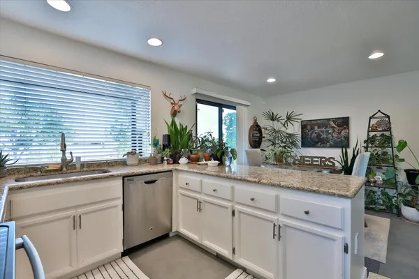 a spacious bedroom with a large bed and a chandelier