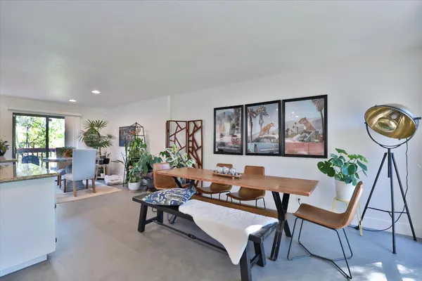 a bedroom with a bed and a chair with the outer view