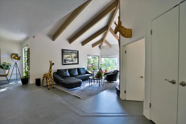 a bed room with furniture and a potted plant