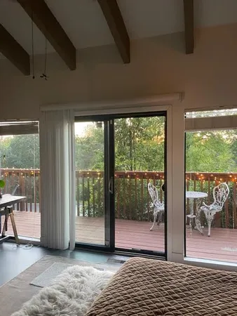 a view of balcony with wooden floor and potted plants