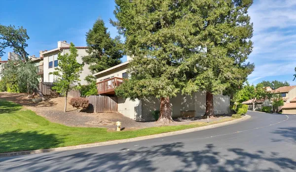 a wooden bench sitting in front of a house