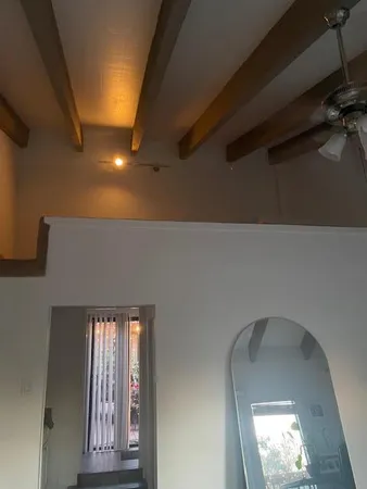 an aerial view of residential house with outdoor space and trees all around