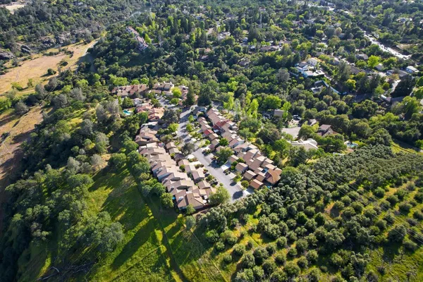 an aerial view of a house with yard and green space