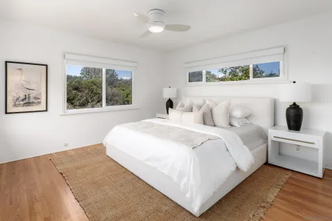 a bedroom with a large bed and a window