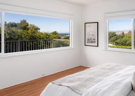 a bedroom with a bed and a window