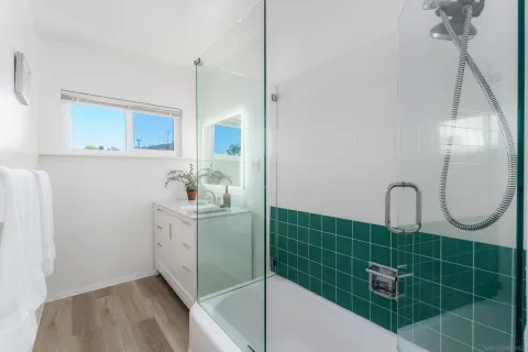a bathroom with a sink a mirror and shower