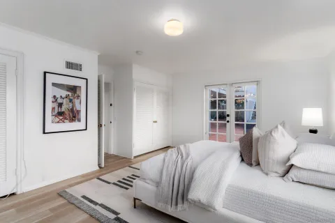 a bedroom with a bed and a window