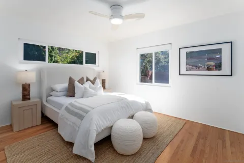 a bedroom with bed and a flat screen tv