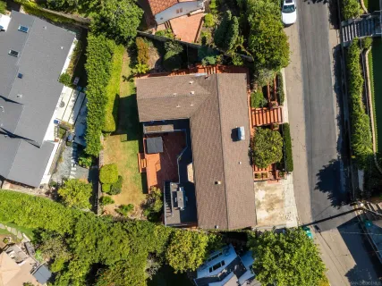an aerial view of a house with a yard