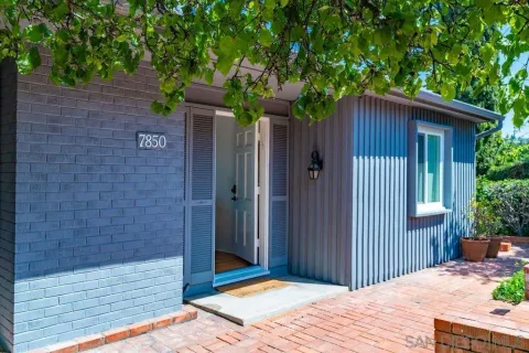 a wooden bench sitting in front of a house