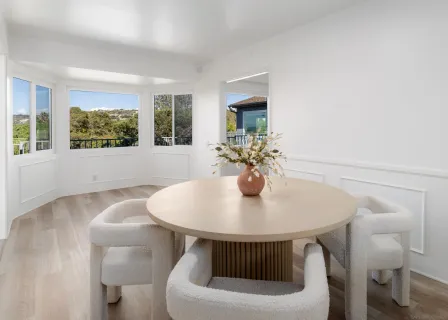 a view of a dining room with furniture and window