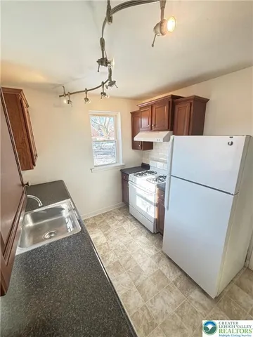 a kitchen with a stove and a refrigerator