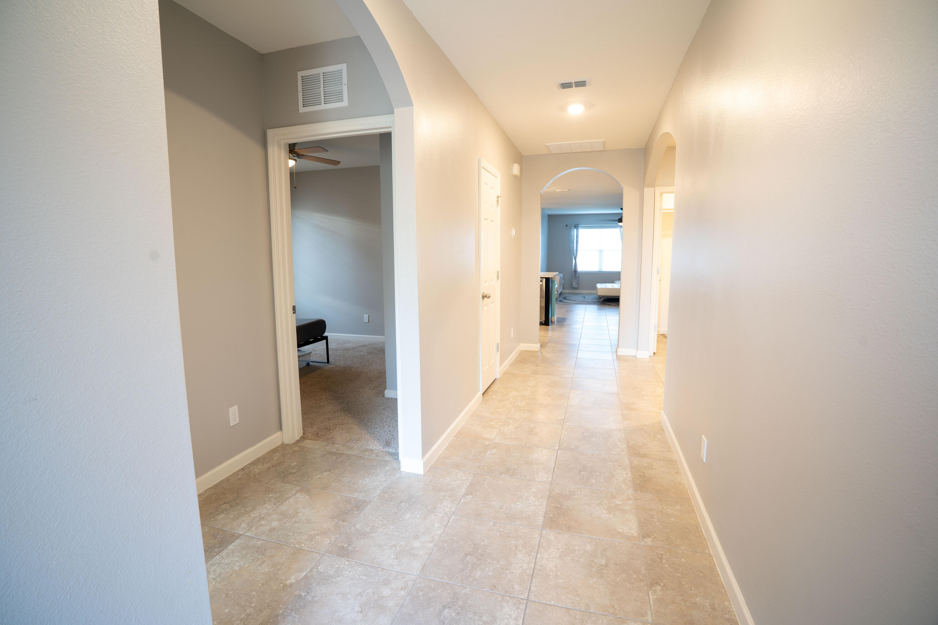1401 Southeast Portillo Road Port St. Lucie, FL 34952 - Photo 2 of 37 a view of a hallway with wooden floor staircase and a bathroom