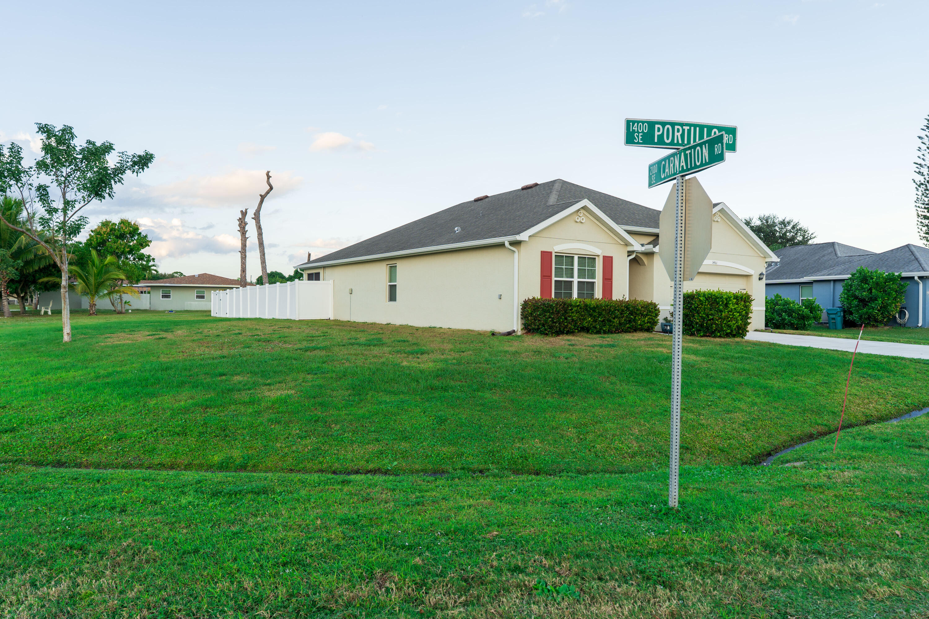 1401 Southeast Portillo Road Port St. Lucie, FL 34952 - Photo 26 of 37 a view of a house with a big yard and potted plants