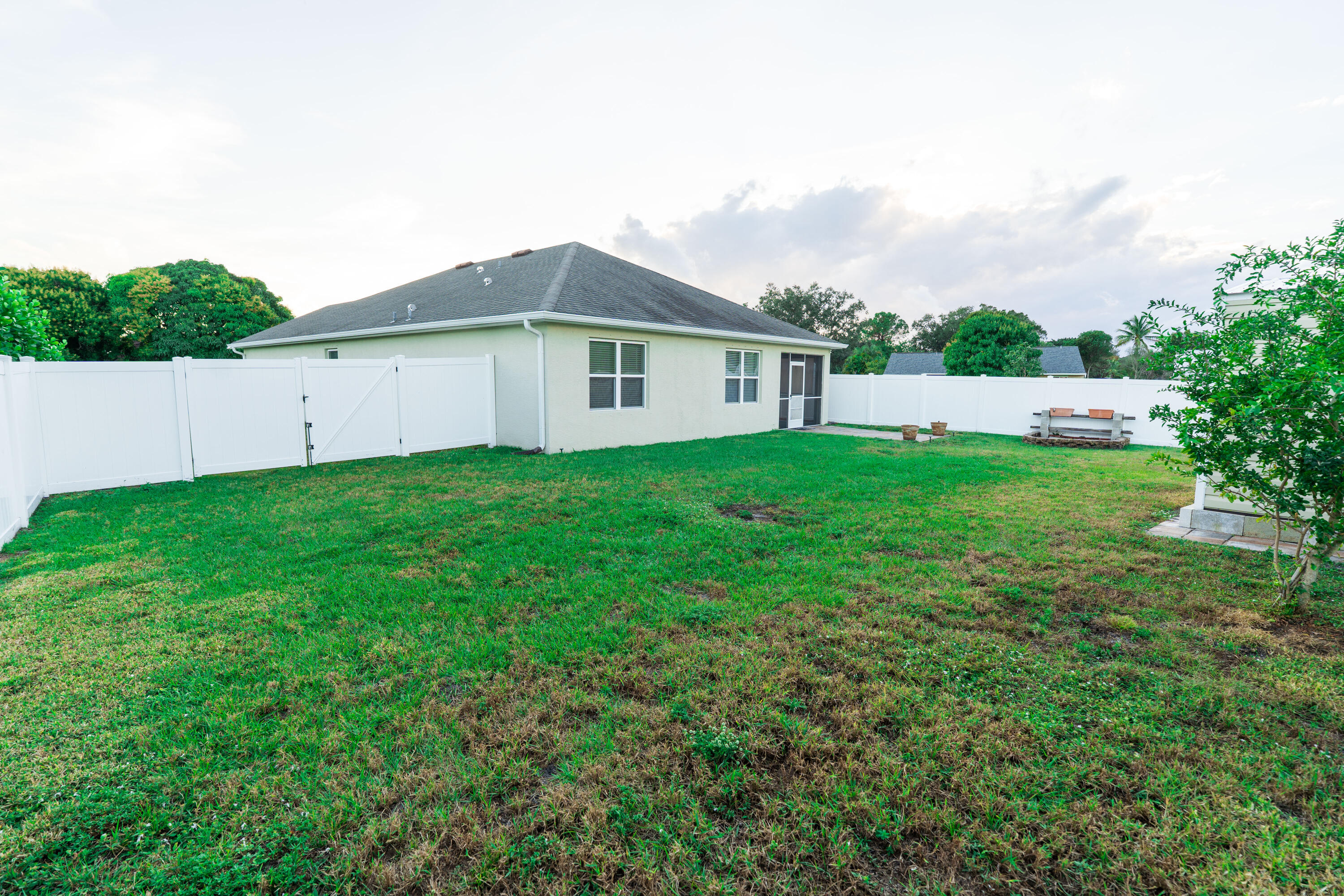 1401 Southeast Portillo Road Port St. Lucie, FL 34952 - Photo 29 of 37 a view of a house with a yard and sitting area