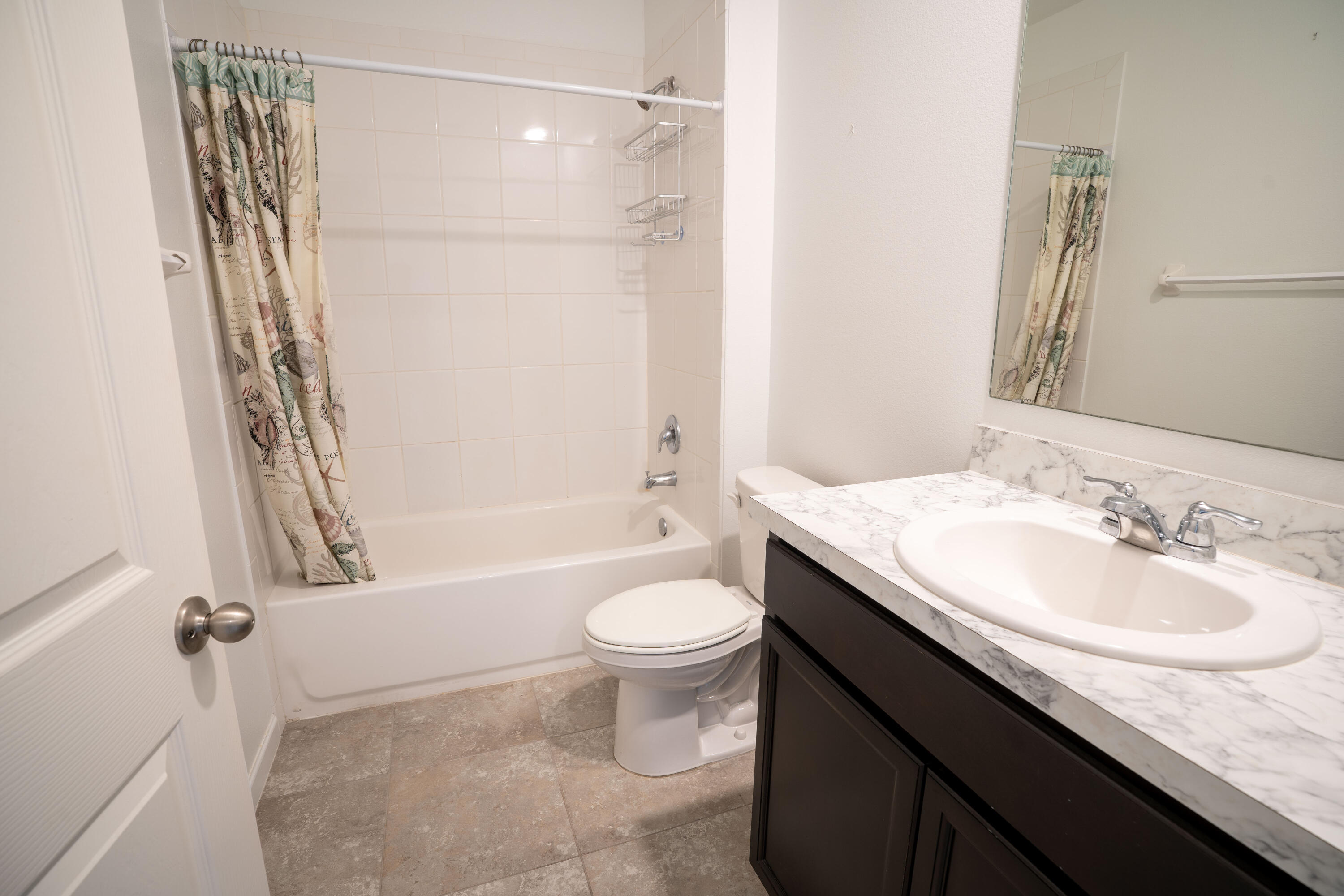 1401 Southeast Portillo Road Port St. Lucie, FL 34952 - Photo 5 of 37 a bathroom with a granite countertop sink toilet and shower